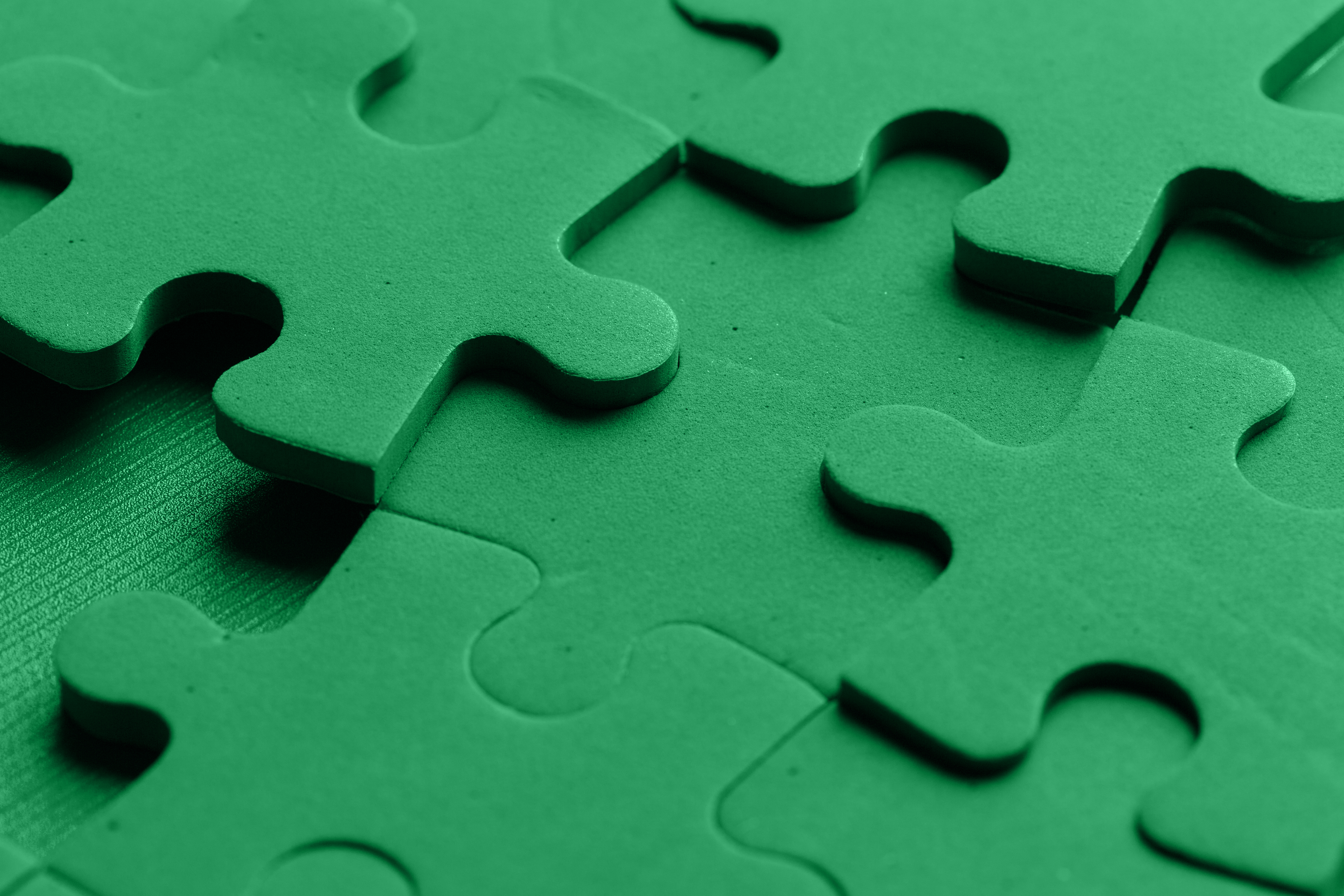 Interlocking pieces of a green puzzle. - Jerone Toledo Frente